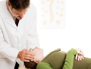 Chiropractor adjusting patient
